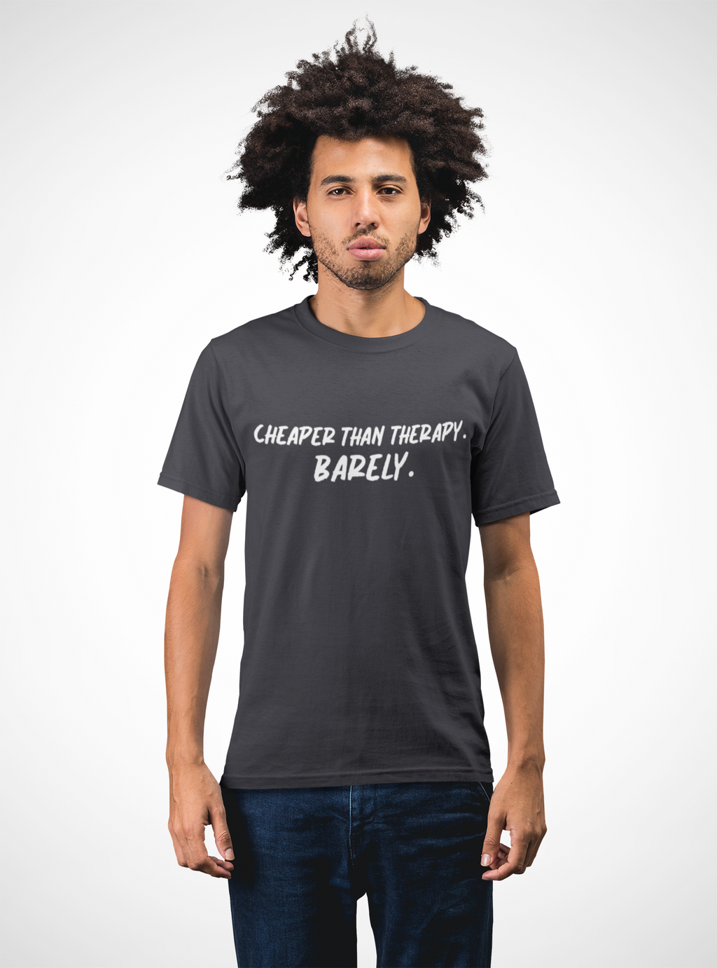 Man wearing a dark gray t-shirt with text  t-shirt with white text "Cheaper than therapy. Barely." on  a white background