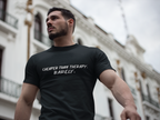 Man wearing a black t-shirt with text, standing in front of a building.