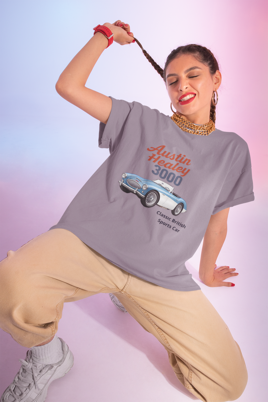Woman wearing a gray t-shirt with an Austin Healey 3000 graphic on a gradient background