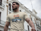 Man wearing a sand t-shirt with an Austin Healey 3000 graphic in front of a building.